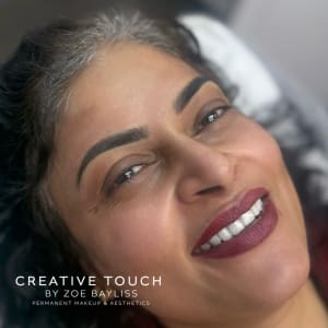 Fresh bold ombré brows on medium-dark skin tone with warm undertones showing defined arch with saturated colour and dimensional gradient