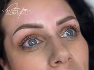 Fresh combination brows on fair skin with cool undertones showing balanced medium brown pigment coordinated with hair strokes and powder shading for natural enhancement