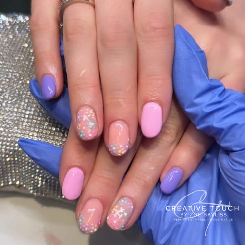 A client's nails showcase the versatility of the beautiful mauve colour palette. A close-up of the client's hands.