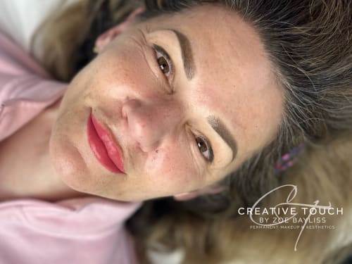 Close-up portrait of a woman with beautiful, soft pixelated eyebrows after receiving an Ombr&eacute; brow treatment at Creative Touch in Rotherham.