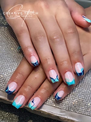 Close-up photo of blue swirl biab nail extensions with builder gel on top. The biab gel creates a smooth, glossy finish and the blue swirls add a touch of whimsy. These nails are perfect for those who want a unique and eye-catching look.