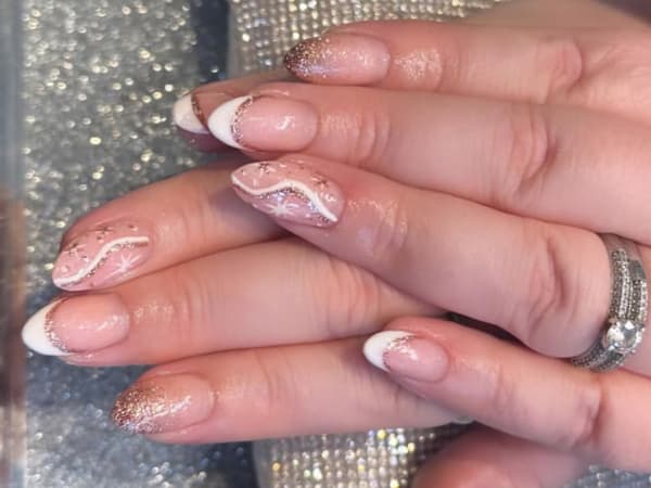 Celestial inspired BIAB nail design with classic french tips and glittery star details