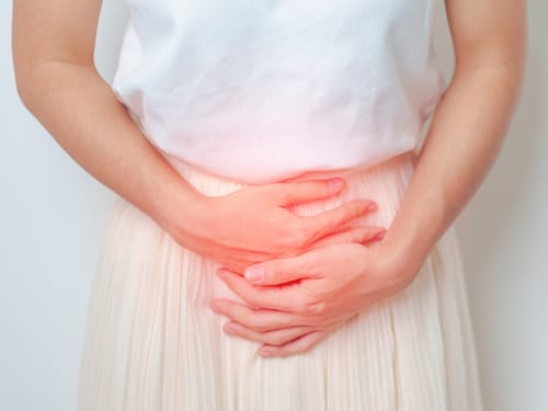 A woman suffering pelvic pain from organ prolapse or hernia.