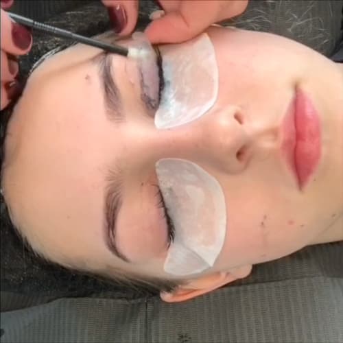Close-up timelapse of a client receiving a lash lift treatment, showing the lashes being lifted and curled from root to tip.