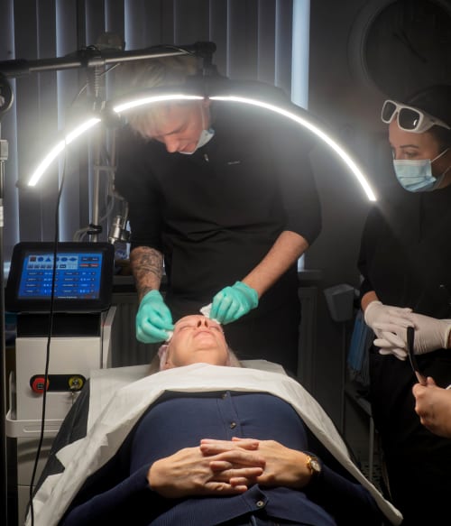 Preparing client's skin prior to beginning thulium treatment