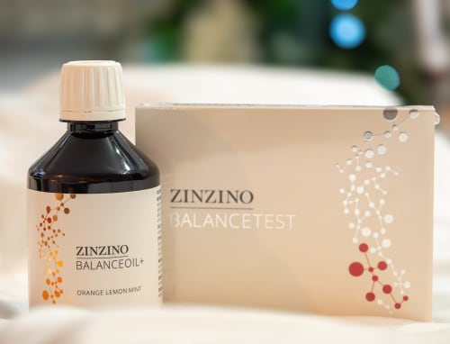 Zinzino BalanceOil+ quality fish oil supplement packaging next to omega-3:omega-6 ratio testing kit