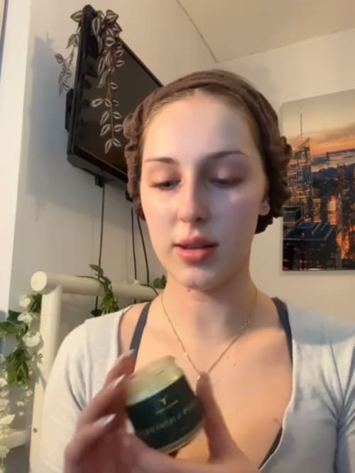 Applying tallow balm by warming a small amount between fingertips before massaging into skin