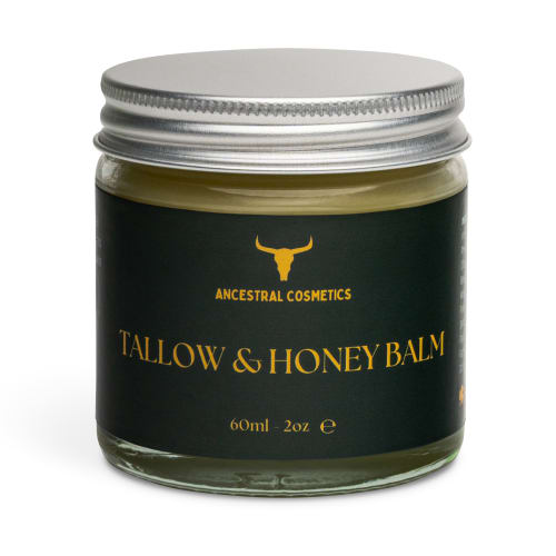 Ancestral Cosmetics Tallow and Honey Balm in a glass jar with a dark green label and silver lid, centered on a white background.