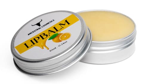 Product cut-out image for tallow lip balm with orange essential oils, showing open pot on a white background