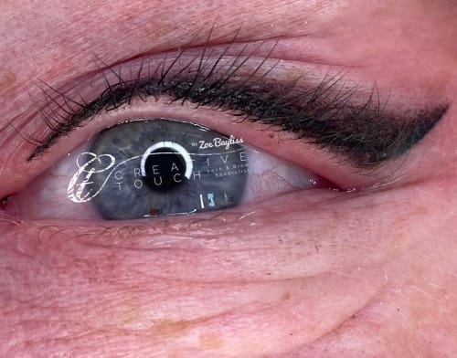 A close-up of a client's smoky eyeliner with a flick